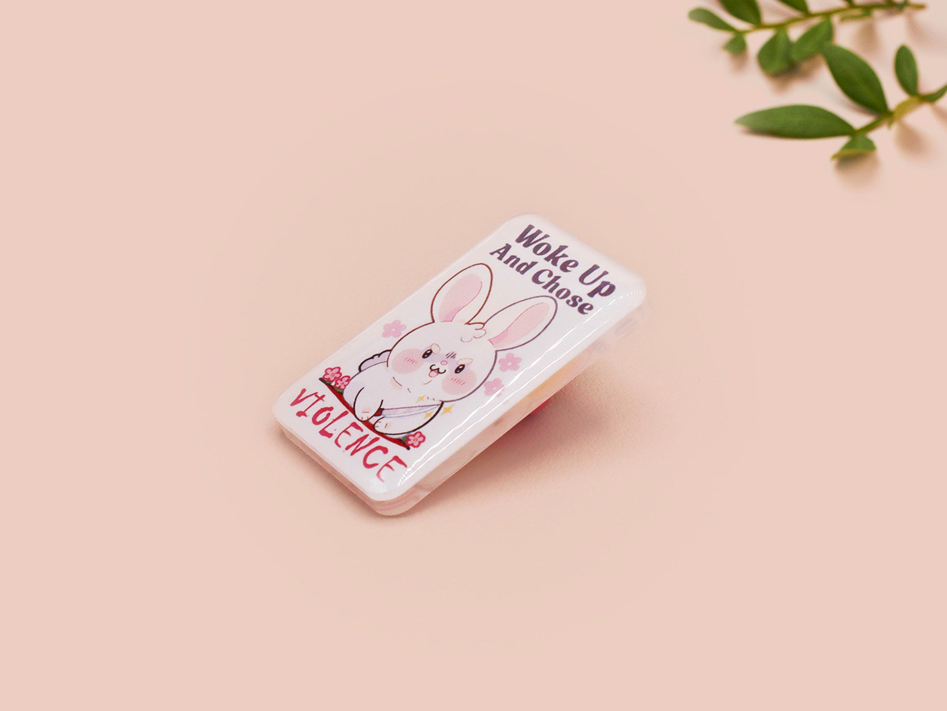 Clear acrylic pin badge with pink heart-shaped rubber pin back clasp. The design of the pin badge is a cute cartoon chibi white rabbit with the quote Woke Up And Chose Violence.