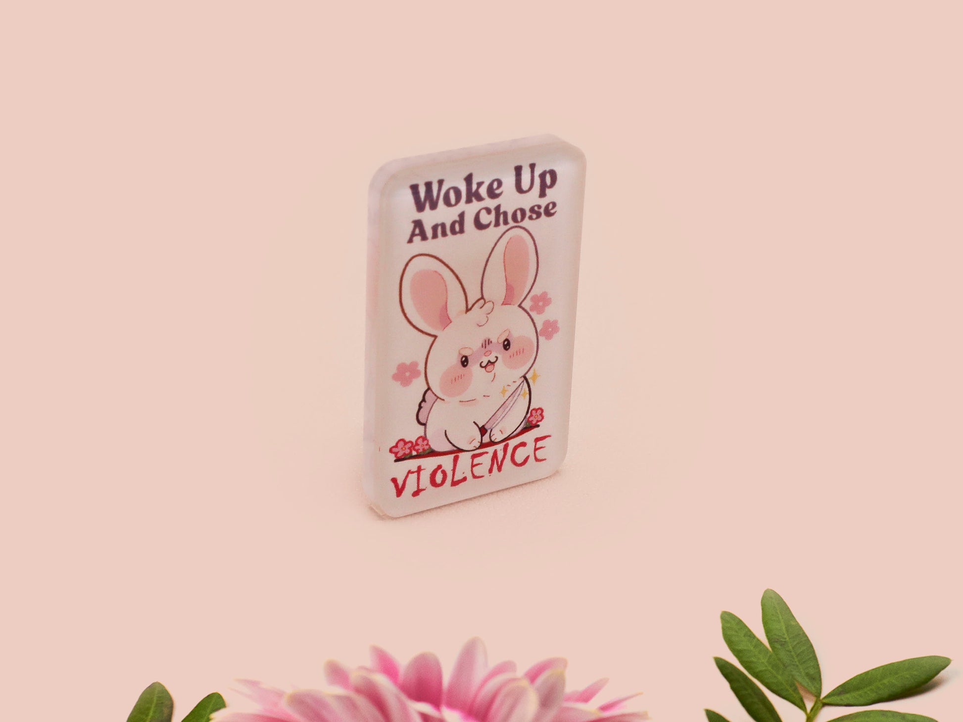 Clear acrylic pin badge with pink heart-shaped rubber pin back clasp. The design of the pin badge is a cute cartoon chibi white rabbit with the quote Woke Up And Chose Violence.