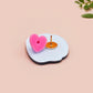 Clear acrylic pin badge with pink heart-shaped rubber pin back clasp. The design of the pin badge is a cute cartoon chibi Mothman cryptid with the quote I believe in Mothman and Mothman believes in me.