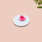 Clear acrylic pin badge with a pink heart-shaped rubber pin back clasp. The design of the pin badge is a cute chibi white cat in a retro astronaut suit with the quote I need space.