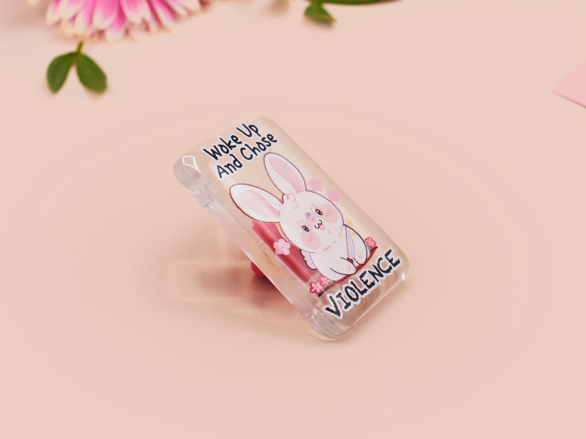 Clear acrylic pin badge with pink heart-shaped rubber pin back clasp. The design of the pin badge is a cute cartoon chibi white rabbit with the quote Woke Up And Chose Violence.
