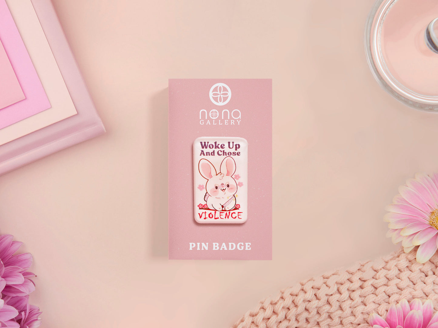 Clear acrylic pin badge with pink heart-shaped rubber pin back clasp. The design of the pin badge is a cute cartoon chibi white rabbit with the quote Woke Up And Chose Violence.