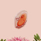A clear acrylic pin badge with a pink heart-shaped pin back clasp. The design of the pin badge is of a cute chibi potato with the quote I'm a lil' stressed potato