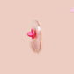 A clear acrylic pin badge with a pink heart-shaped pin back clasp. The design of the pin badge is of a cute chibi potato with the quote I'm a lil' stressed potato