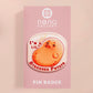 A clear acrylic pin badge with a pink heart-shaped pin back clasp. The design of the pin badge is of a cute chibi potato with the quote I'm a lil' stressed potato