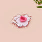 Clear acrylic pin badge with pin heart-shaped pin back clasp. The design of the pin badge is a cute cartoon ginger cat sat in a small cardboard box with the quote if I fits I sits.