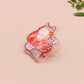 Clear acrylic pin badge with pin heart-shaped pin back clasp. The design of the pin badge is a cute cartoon ginger cat sat in a small cardboard box with the quote if I fits I sits.