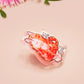 Clear acrylic pin badge with pin heart-shaped pin back clasp. The design of the pin badge is a cute cartoon ginger cat sat in a small cardboard box with the quote if I fits I sits.