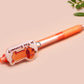 Orange ballpoint pen with black ink and a cute chibi dachshund sausage dog design.