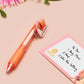 Orange ballpoint pen with black ink and a cute chibi dachshund sausage dog design.