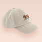 Vintage cream baseball cap with an embroidered design of a cute dachshund dog looking concerned and the quote "In This Economy?"