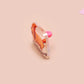 A clear acrylic pin badge with a pink heart-shaped pin back clasp. The design of the pin badge is of a cute chibi dachshund sausage dog with the quote in this economy?