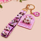 Acrylic epoxy possum keychain with a large acrylic charm of a purple screaming possum with the quote is it me am I the drama, a smaller charm of a cute crying possum and a matching purple possum lanyard.