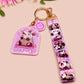 Acrylic epoxy possum keychain with a large acrylic charm of a purple screaming possum with the quote is it me am I the drama, a smaller charm of a cute crying possum and a matching purple possum lanyard.