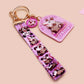 Acrylic epoxy possum keychain with a large acrylic charm of a purple screaming possum with the quote is it me am I the drama, a smaller charm of a cute crying possum and a matching purple possum lanyard.