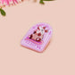 A clear acrylic pin badge with a pink heart-shaped pin back clasp. The design of the pin badge is of a cute screaming possum with the quote is it me am I the drama?
