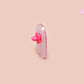 A clear acrylic pin badge with a pink heart-shaped pin back clasp. The design of the pin badge is of a cute screaming possum with the quote is it me am I the drama?