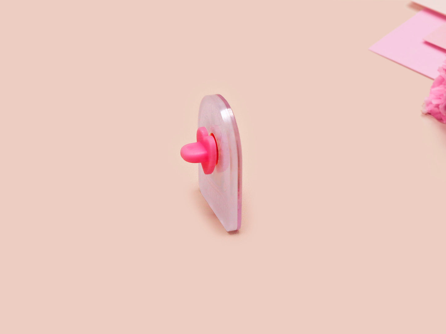 A clear acrylic pin badge with a pink heart-shaped pin back clasp. The design of the pin badge is of a cute screaming possum with the quote is it me am I the drama?