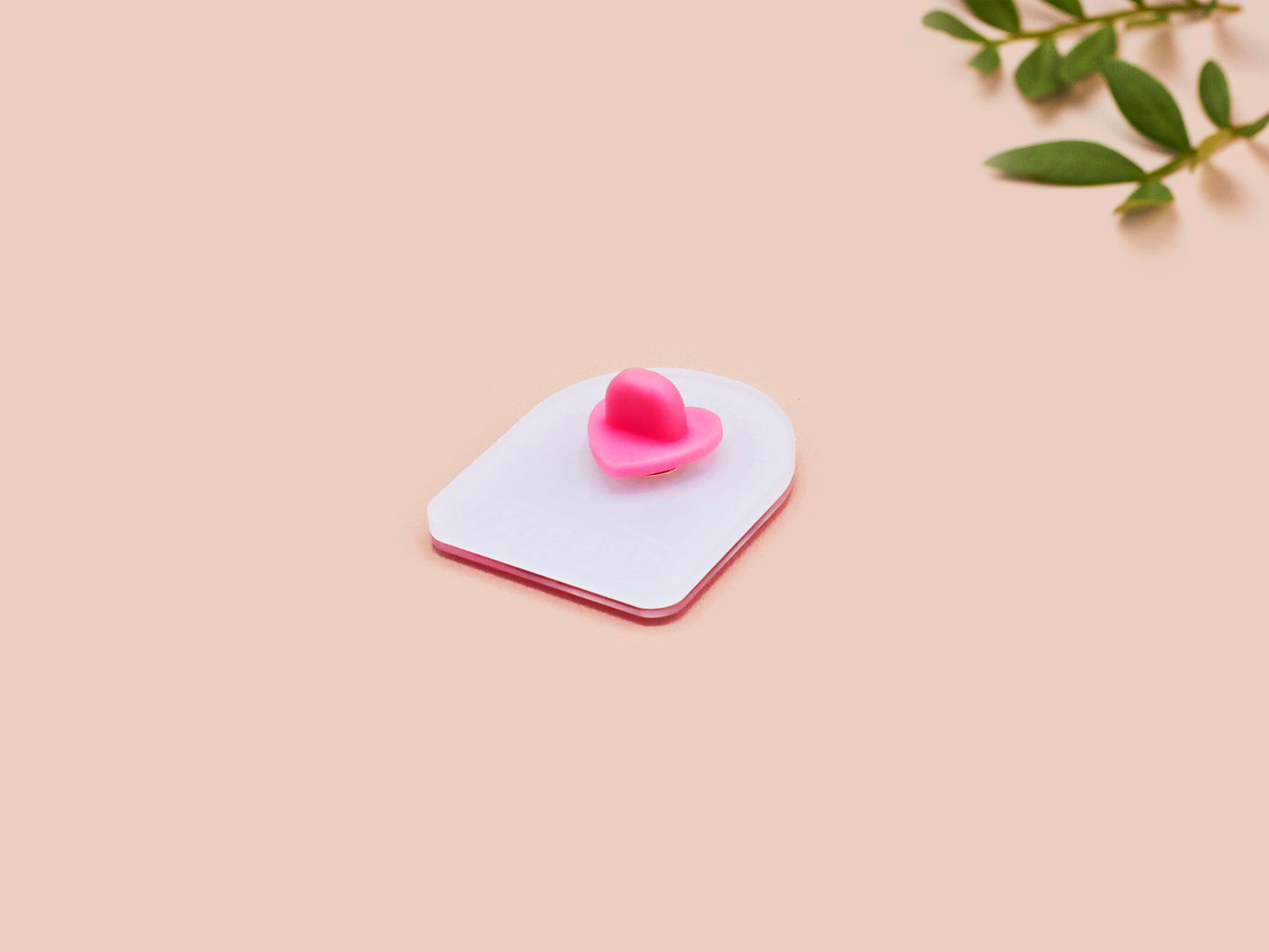 A clear acrylic pin badge with a pink heart-shaped pin back clasp. The design of the pin badge is of a cute screaming possum with the quote is it me am I the drama?