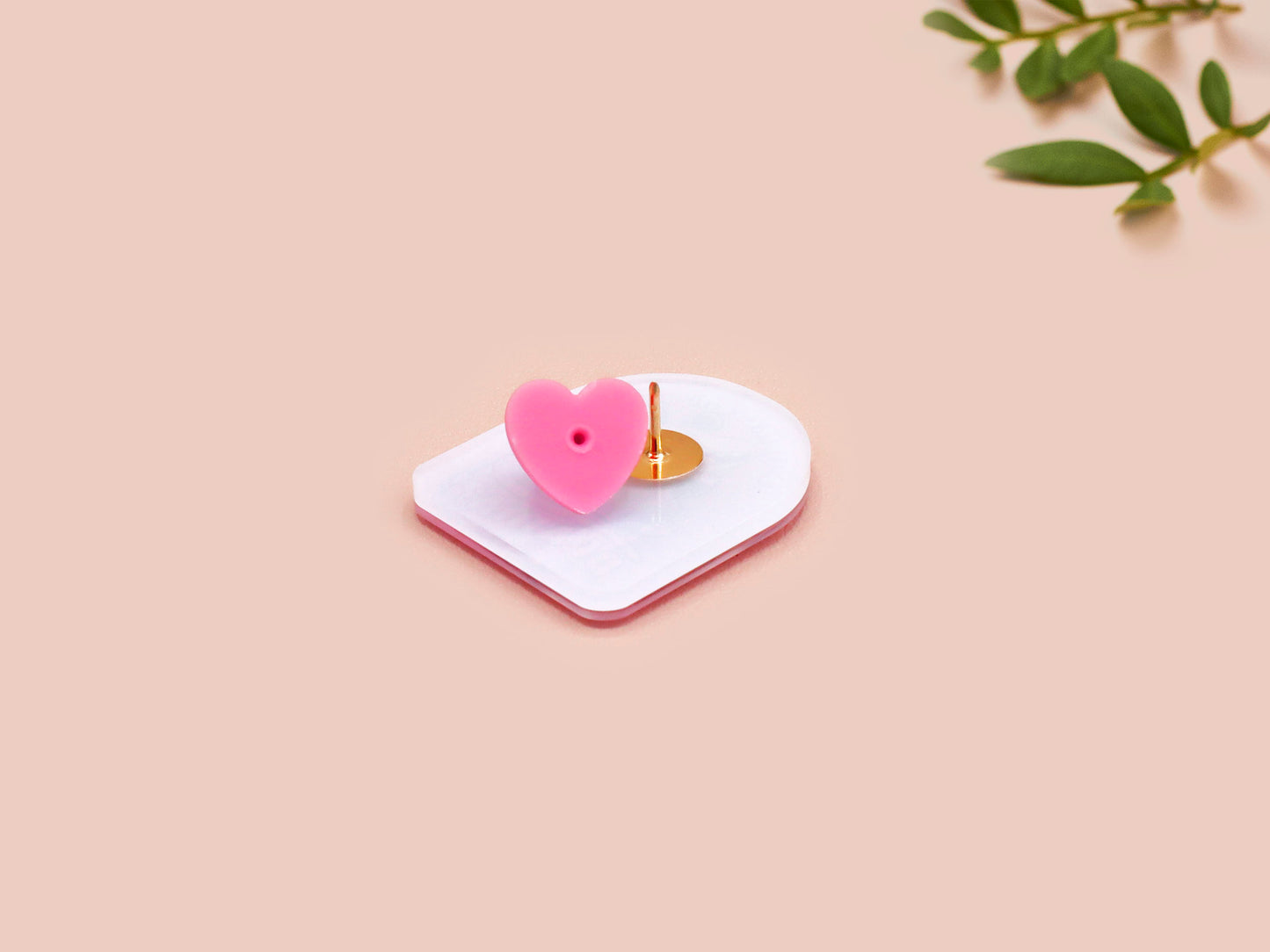 A clear acrylic pin badge with a pink heart-shaped pin back clasp. The design of the pin badge is of a cute screaming possum with the quote is it me am I the drama?