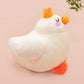 An adorable white duck bird plushie toy with cute embroidered eyes and facial expression, wearing a yellow crown hat, with a hang tag describing the duck as King Larry.