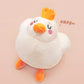 An adorable white duck bird plushie toy with cute embroidered eyes and facial expression, wearing a yellow crown hat, with a hang tag describing the duck as King Larry.