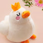 An adorable white duck bird plushie toy with cute embroidered eyes and facial expression, wearing a yellow crown hat, with a hang tag describing the duck as King Larry.
