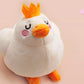 An adorable white duck bird plushie toy with cute embroidered eyes and facial expression, wearing a yellow crown hat, with a hang tag describing the duck as King Larry.