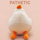 An adorable white duck bird plushie toy with cute embroidered eyes and facial expression, wearing a yellow crown hat, with a hang tag describing the duck as King Larry.