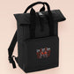 Black roll top backpack with a front pocket and an embroided mothman cryptid design with the lext live lamp lurk