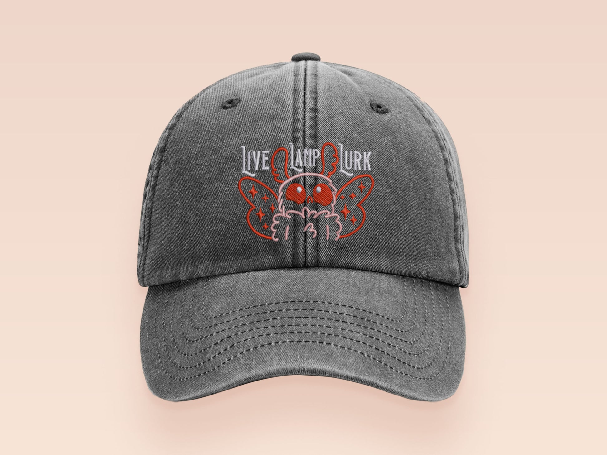A vintage dark grey baseball cap hat with an embroidered cute chibi Mothman crytid with the quote Live Lamp Lurk.