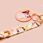 Acrylic epoxy meme cat keychain with a large acrylic charm of popcat , a smaller charm of smudge cat and a matching lanyard with multiple different internet famous meme cats.