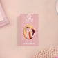 Clear acrylic pin badge with pink heart-shaped rubber pin back clasp. The design of the pin badge is a cute viral internet meme cat with a cheeky relatable reaction.