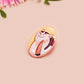 Clear acrylic pin badge with pink heart-shaped rubber pin back clasp. The design of the pin badge is a cute viral internet meme cat with a cheeky relatable reaction.