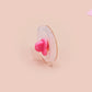 Clear acrylic pin badge with pink heart-shaped rubber pin back clasp. The design of the pin badge is a cute viral internet meme cat with a cheeky relatable reaction.