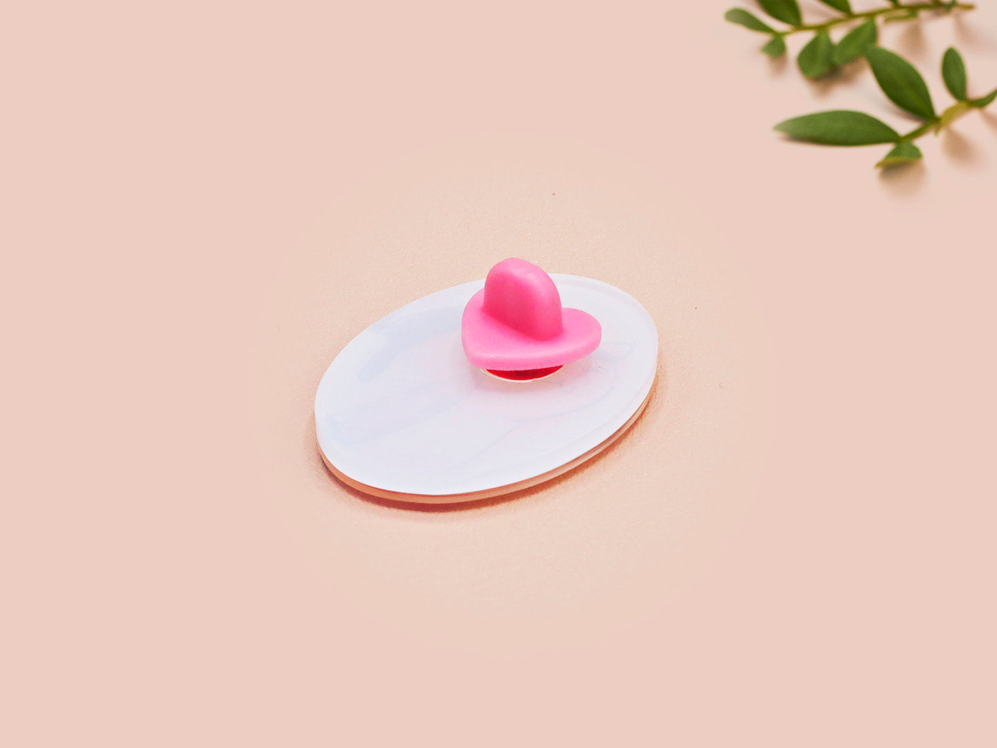 Clear acrylic pin badge with pink heart-shaped rubber pin back clasp. The design of the pin badge is a cute viral internet meme cat with a cheeky relatable reaction.