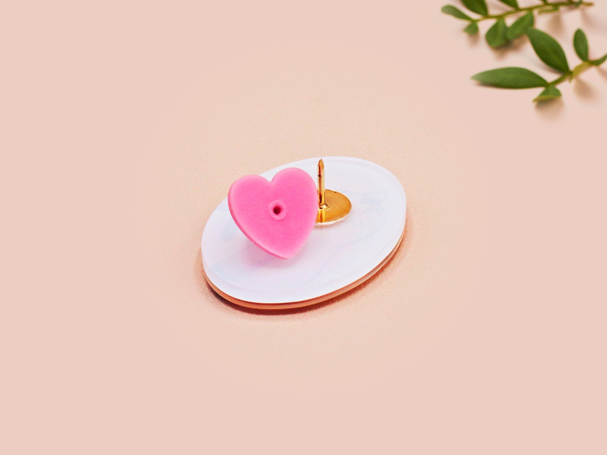 Clear acrylic pin badge with pink heart-shaped rubber pin back clasp. The design of the pin badge is a cute viral internet meme cat with a cheeky relatable reaction.