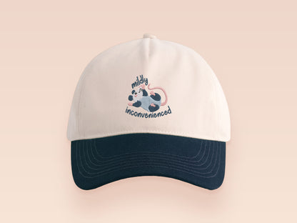 Vintage style truckers baseball cap with a contrast cream and navy peak design with an embroidered possum playing dead and the quote mildly inconveninced 