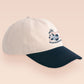 Vintage style truckers baseball cap with a contrast cream and navy peak design with an embroidered possum playing dead and the quote mildly inconveninced 