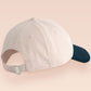 Vintage style truckers baseball cap with a contrast cream and navy peak design with an embroidered possum playing dead and the quote mildly inconveninced 
