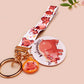 Acrylic keychain with a large charm of the fat angry pygmy hippo being picked up, a smaller charm of a cute baby hippo with the name Moo Deng in Thai and a matching mini lanyard of the pygmy hippo in multiple cute poses and expressions.