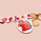 Acrylic keychain with a large charm of the fat angry pygmy hippo being picked up, a smaller charm of a cute baby hippo with the name Moo Deng in Thai and a matching mini lanyard of the pygmy hippo in multiple cute poses and expressions.