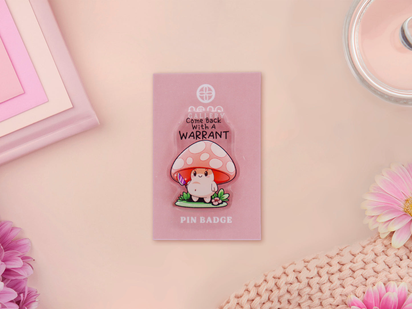 Acrylic Pin Badge on backing card of a smiling but ominous mushroom chibi with the quote come back with a warrant written above.