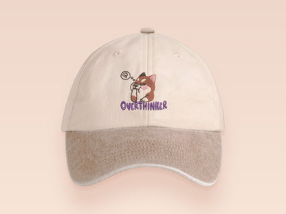 Vintage style truckers baseball cap with a contrast cream and sand peak design with an embroidered cute shiba inu dog overthinking with the quote Overthinker