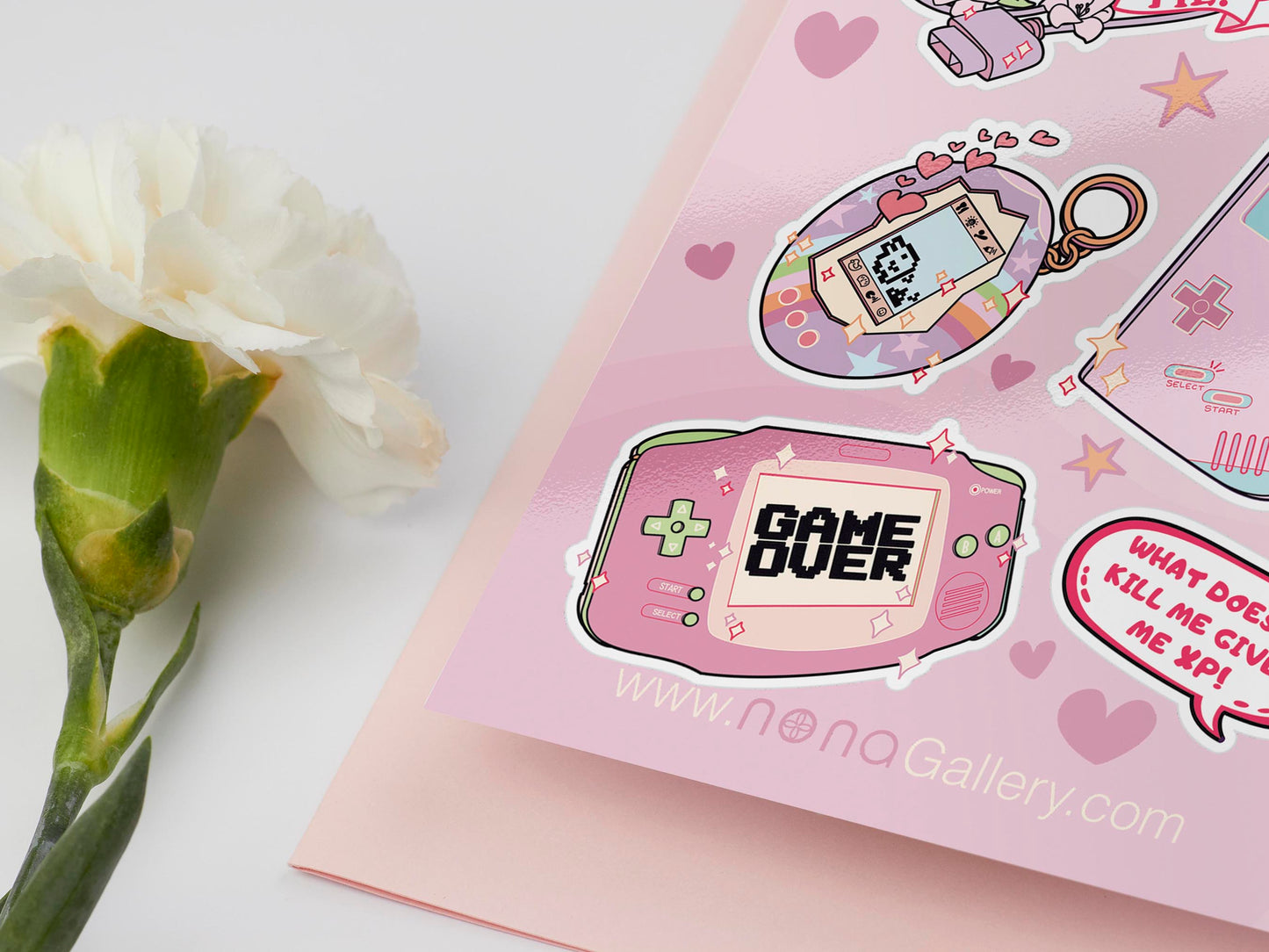 Large sticker sheet of digital illustration cartoons of various cute retro gaming consoles and technology, such as Tamagotchis, tabletop dice, nintendo gameboy, nes, handheld consoles, controllers, quotes and other items.