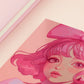 A square art print depicting a cute pink haired girl with freckles wearing a large pink bow