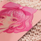A square art print depicting a cute pink haired girl with freckles wearing a large pink bow