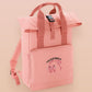 Pink roll top twin handle backpack with an embroided design of cute crying pig and the quote please do not percive me