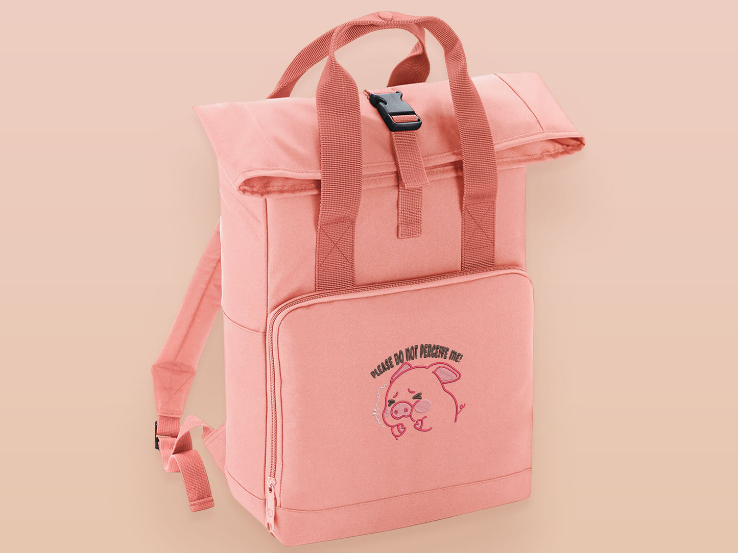 Pink roll top twin handle backpack with an embroided design of cute crying pig and the quote please do not percive me