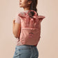 Pink roll top twin handle backpack with an embroided design of cute crying pig and the quote please do not percive me